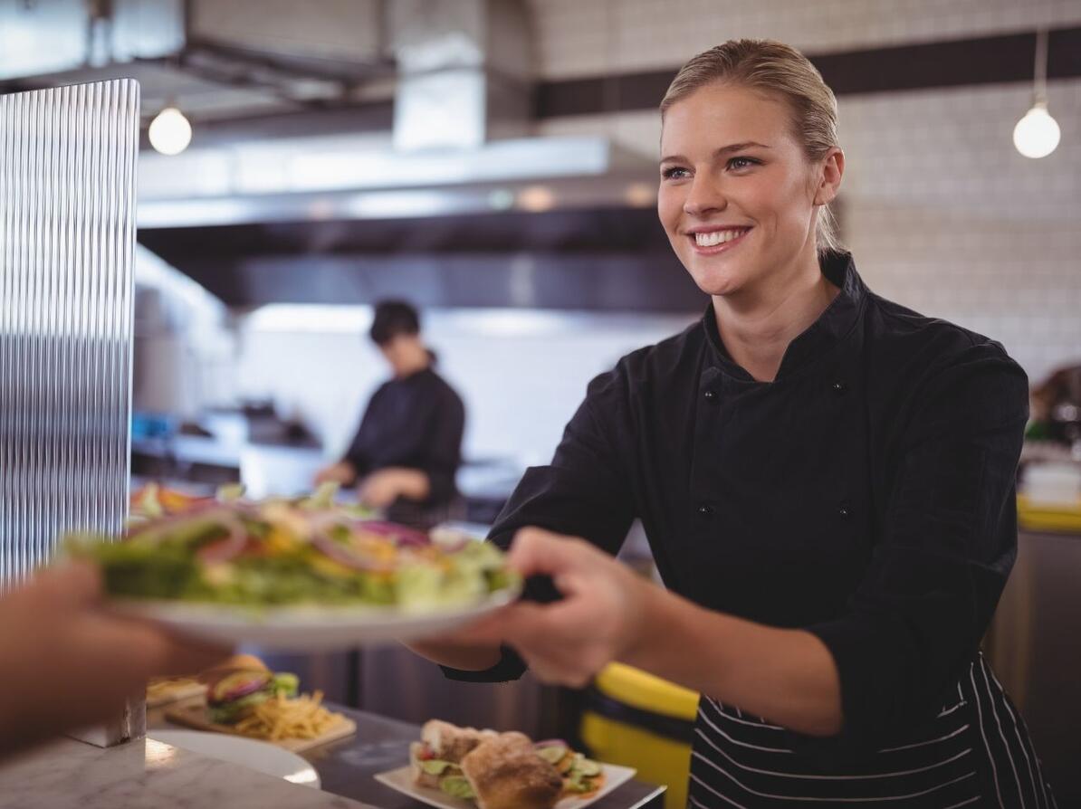 køkkenpersonale serverer mad